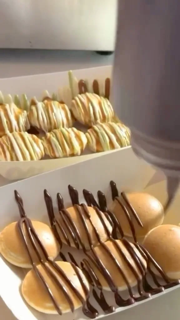 Mini pancakes with chocolate and white chocolate drizzle